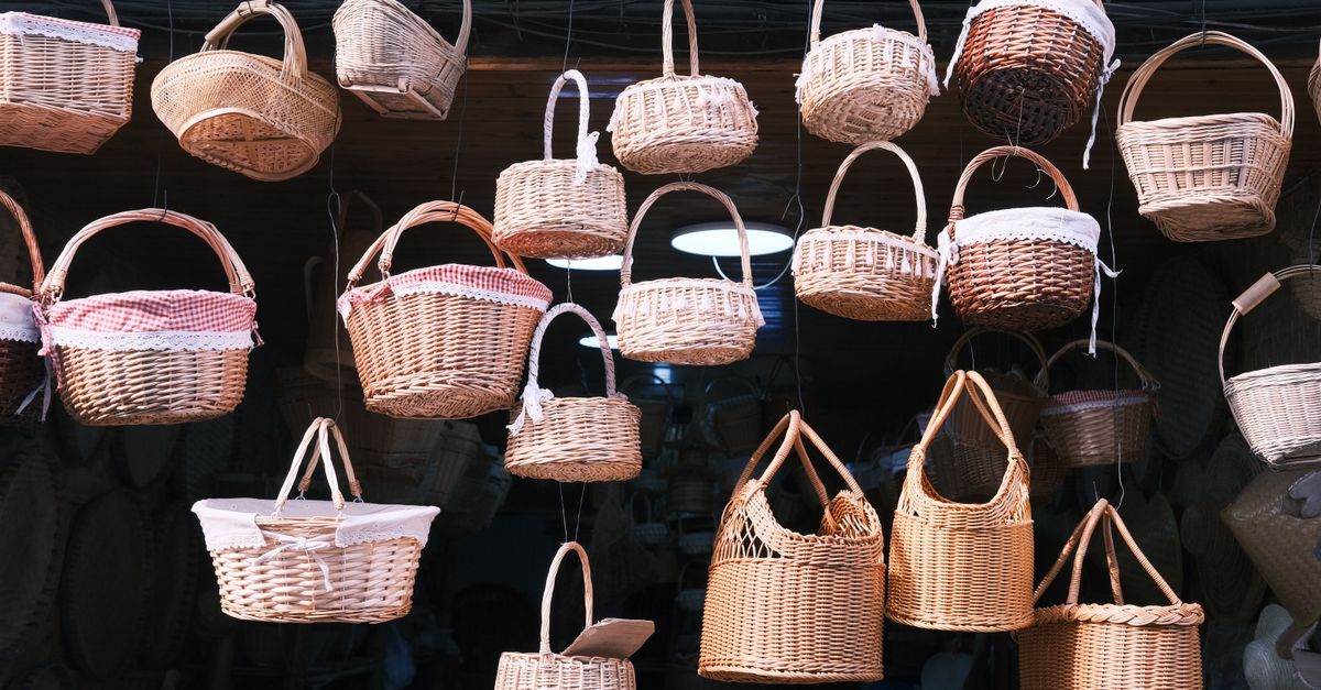 A selection of wicker baskets hanging indoors, showcasing different styles and textures.