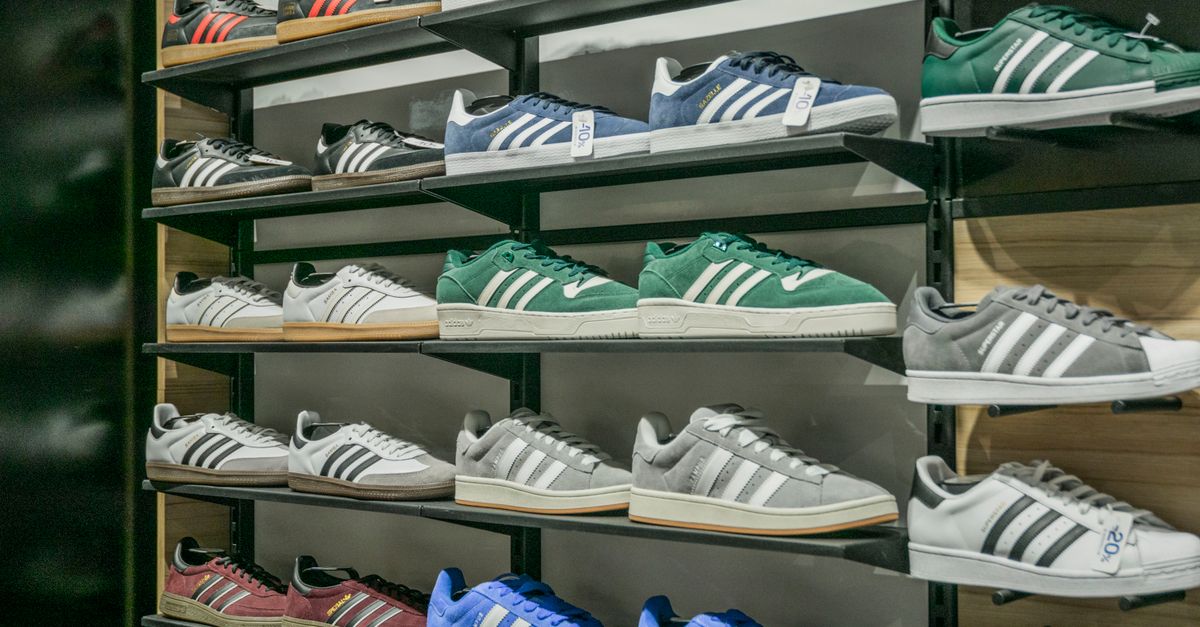 Colorful sneakers arranged on store shelves showcasing trendy footwear options.