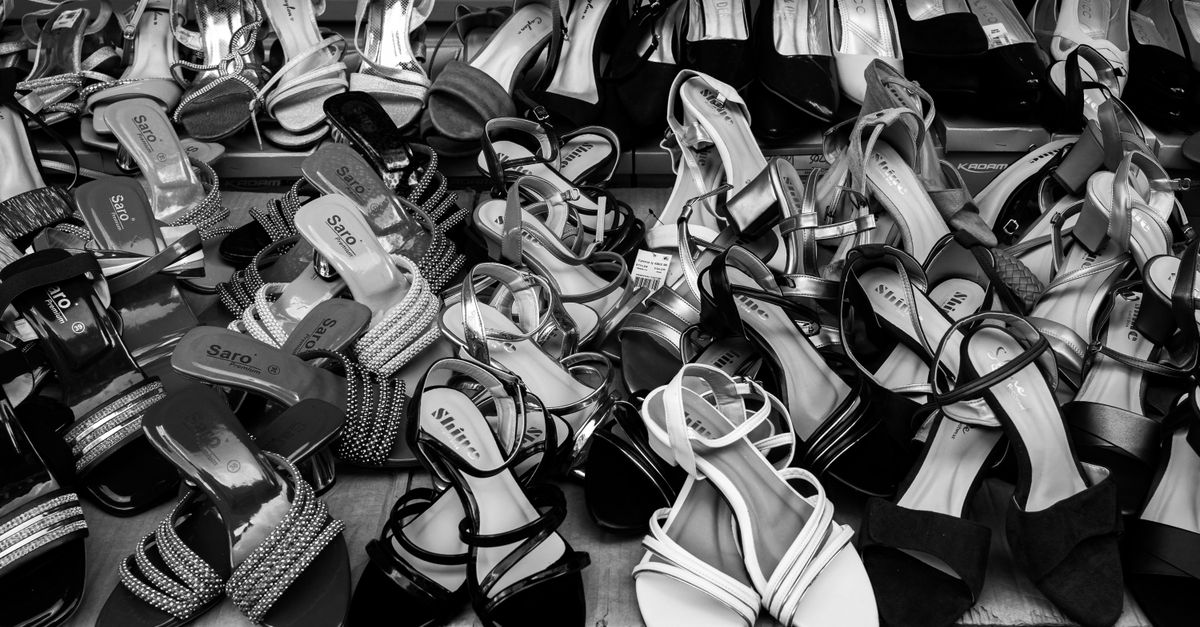 A monochrome display of various women's footwear at a market in Colombo, Sri Lanka.