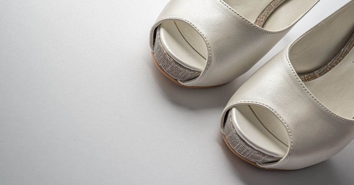 White bridal shoes with open toe design, ideal for weddings and special occasions.